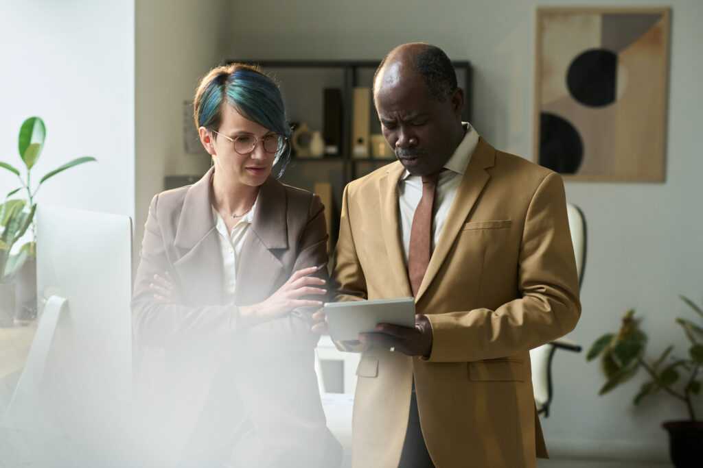 two colleagues looking at tablet screen