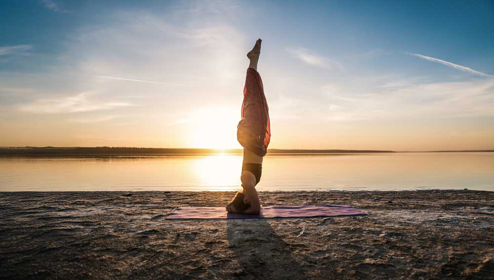 silhouette yoga woman on the beach mobile